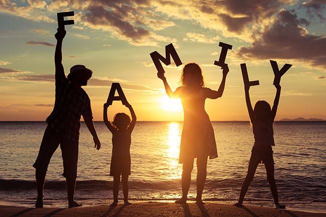 a family holding the alphabets for family individually