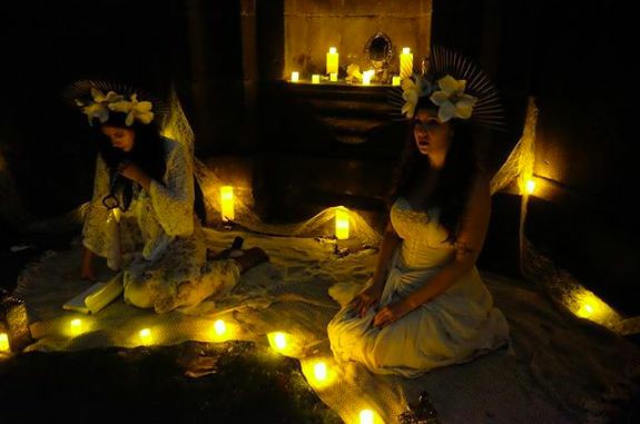 women sitting in fairy lights
