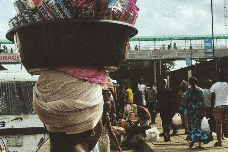 an aba woman with a bowl of mineral with her head