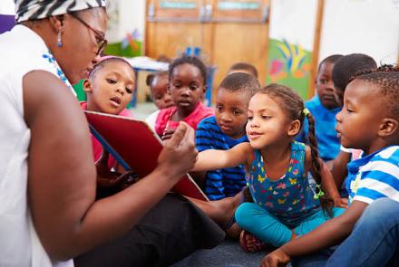 Black teacher with black kids in a school 